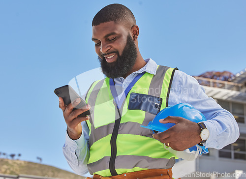 Image of Black man, online or architect with phone on construction site for building update, social media or networking. Smile, news or happy African engineer texting to chat on digital mobile app on Internet