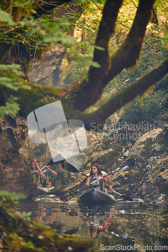 Image of A group of friends enjoying having fun and kayaking while exploring the calm river, surrounding forest and large natural river canyons