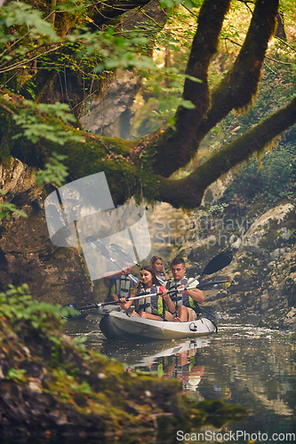 Image of A group of friends enjoying having fun and kayaking while exploring the calm river, surrounding forest and large natural river canyons