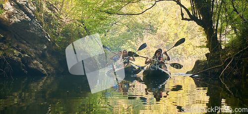 Image of A group of friends enjoying having fun and kayaking while exploring the calm river, surrounding forest and large natural river canyons