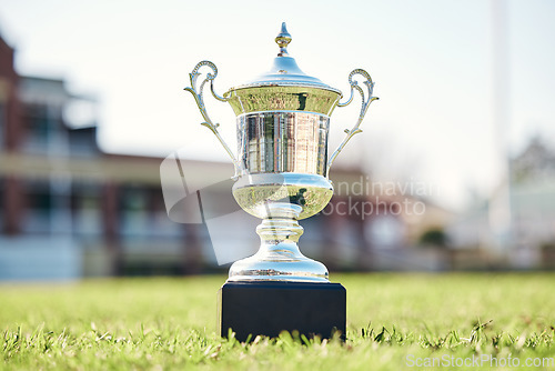 Image of Trophy on grass, champion and award with fitness outdoor, competition and game with mockup space. Prize on pitch, reward and tournament cup with goals, stadium and sports ground field with winner