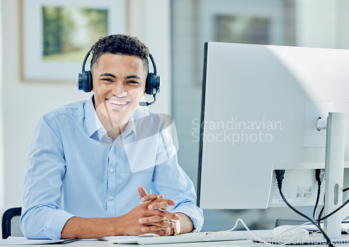 Image of Telemarketing, portrait and man with a smile, call center and employee with headphones, tech support and customer service. Agent, consultant and person with a headset, computer and help desk for crm