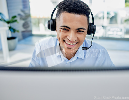 Image of Call center, customer service and male consultant in the office doing an online consultation. Contact us, crm and professional young man telemarketing agent working with a headset in the workplace.