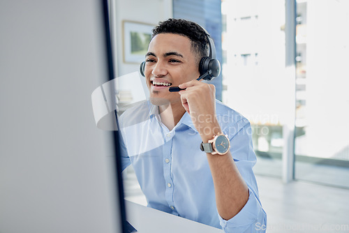 Image of Customer support, call center and male agent in the office doing an online consultation. Contact us, crm and professional young man telemarketing consultant on a call with a headset in the workplace.