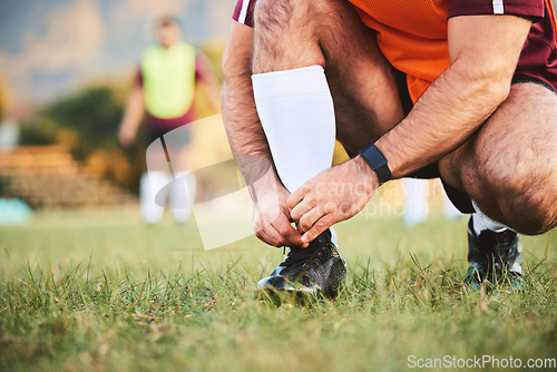 Image of Rugby, hands and athlete tie shoes to start workout, exercise or fitness. Sports, player and man tying boots in training preparation, game or competition for healthy body or wellness on field outdoor