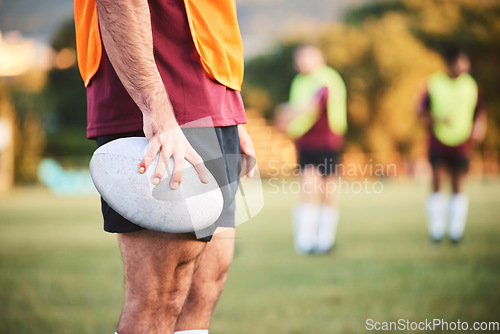 Image of Rugby, man and closeup with ball for sports games, competition and contest on field. Hands of athlete, person and outdoor training at stadium for fitness, exercise and performance challenge on pitch