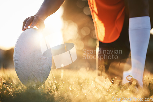 Image of Rugby, ball closeup and sun, sports on field outdoor with bokeh, target with fitness and train for match. Exercise, athlete person hand and game with practice, health and active with player and ready