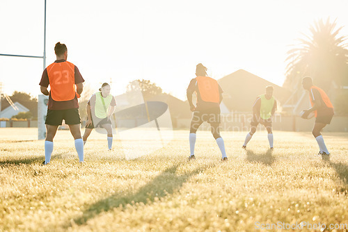 Image of Team, practice or rugby men in training, exercise or workout match on sports field playing in summer. Sunshine, group or people ready for competitive game challenge with physical fitness or wellness