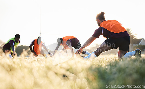 Image of Rugby, team and group stretching at training for match or competition in the morning doing warm up exercise on grass. Wellness, teamwork and people or players workout together in professional sports