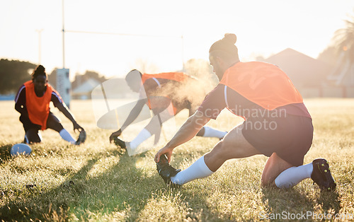 Image of Rugby, team and people stretching at training for match or competition in the morning doing warm up exercise on grass. Wellness, teamwork and group of players workout together in professional sports