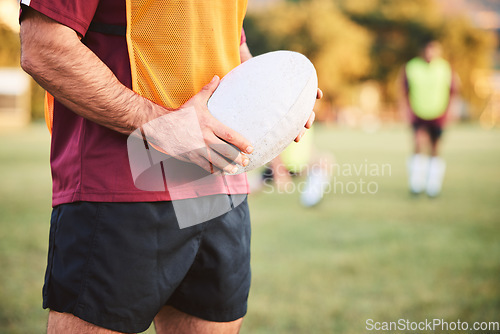 Image of Rugby, man and hands with ball for sports games, competition and contest on field. Closeup of athlete, team player and training at stadium for fitness, exercise and performance of challenge outdoor