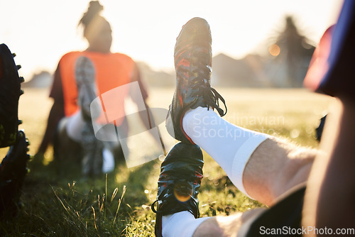 Image of Rugby, stretching legs and people on field for sports, team training or together in the morning. Grass, fitness and athlete players with a warm up for a game, workout or performance in a competition