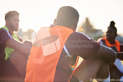 Image of Group, rugby and men relax on field outdoor, talking and communication at sunrise in the morning. Sports, athlete team and players sitting together after exercise, training or friends workout in game