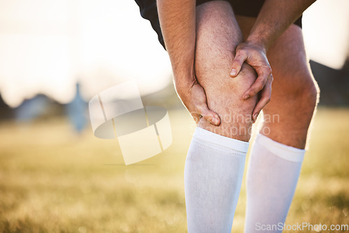 Image of Knee pain, man with injury and exercise accident, athlete outdoor with cramps and muscle tension. Fitness, sports and male person with hands on leg, health crisis and rugby player with inflammation