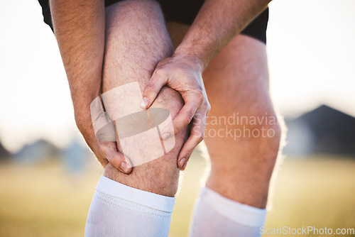 Image of Knee pain, man with injury and fitness accident, athlete outdoor with cramps and muscle tension. Exercise, sports and male person with hands on leg, health crisis and rugby player with inflammation