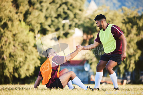 Image of Rugby, teamwork and a sports man helping a friend while training together on a stadium field for fitness. Partnership, exercise and team building with an athlete and teammate outdoor for support