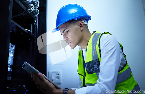 Image of Man, electrician and tablet for power maintenance, server room or data center upgrade in IT or cybersecurity. Young, engineering person on digital tech for network programming, electricity and cables