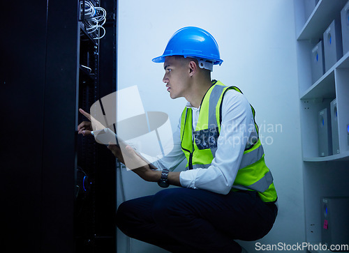 Image of Man, engineering and tablet for power maintenance, server room or data center inspection in IT cybersecurity. Young, electrician person on digital tech for network programming, electricity and cables