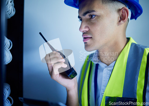 Image of Man, engineering and radio in server room for communication, power update and inspection. Young technician, electrician or contractor check cables, security system or electricity with walkie talkie