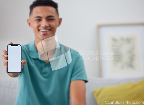 Image of Phone screen, mockup and portrait of man on sofa for networking, social media and space. Internet, show and mobile app with person in living room of home for ui, communication and website offer