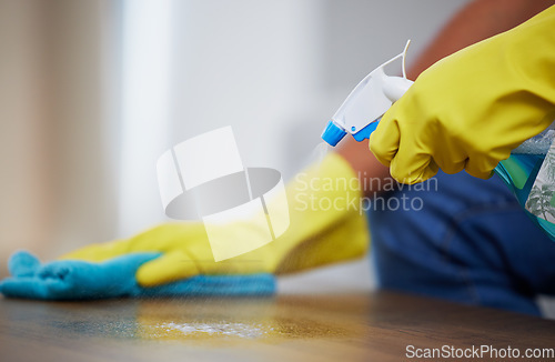 Image of Cleaning spray, wipe and hands of a person on a table for dust, housekeeping service and morning routine. Dirt, hygiene and cleaner with liquid detergent for a sanitary counter for a fresh home