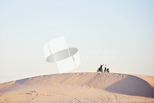 Image of Desert blue sky, motorbike and sports people high five, excited celebrate travel, teamwork or off road achievement. Motorcycle adventure, mockup winner or athlete driver collaboration on sand dunes