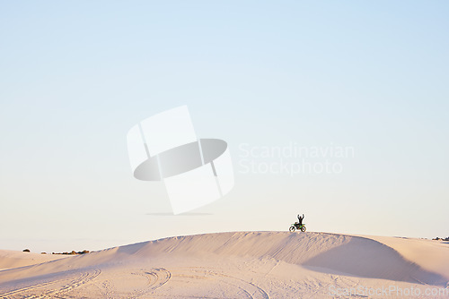 Image of Desert blue sky, motorbike and sports person celebrate travel, journey or off road adventure, freedom and victory. Motorcycle, mockup winner or athlete driver, racer or excited rider cheers on dunes