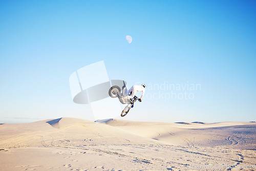 Image of Desert, motorbike jump or sports person travel, agile or driving on off road adventure, air freedom or bike journey. Motorcycle challenge, blue sky or extreme action driver, talent and skill training