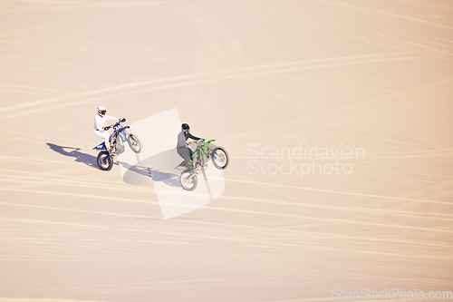 Image of Motorcycle, sand and sports with people in the desert for adrenaline, adventure or training in nature. Bike, summer and freedom with friends outdoor together to wheelie while riding on mockup space