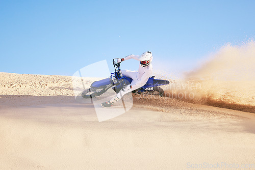 Image of Bike, sand and sports with a man in the desert for adrenaline, adventure or training in nature. Moto, exercise and dust with a male athlete moving on dunes for freedom, energy or balance in summer