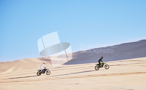 Image of Bike, sand and race with people in the desert for adrenaline, adventure or training in nature. Sports, energy and freedom with friends in a remote location for a motorcycle competition in Dubai