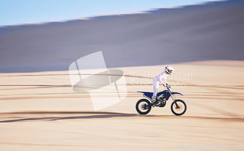 Image of Bike, training and space with a man in the desert for fitness or an adrenaline hobby for freedom. Motorcycle, sports and summer with a male athlete riding a vehicle in Dubai for energy or balance