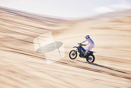 Image of Motorcycle, sports and space with a man in the desert for fitness or an adrenaline hobby for freedom. Bike, training and summer with a male athlete riding a vehicle in Dubai for energy or balance