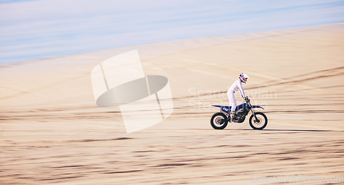 Image of Bike, sports and space with a man in the desert for fitness or an adrenaline hobby for freedom. Motorcycle, training and summer with a male athlete riding a vehicle in Dubai for energy or balance