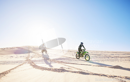 Image of Bike, sports and race with people in the desert for fitness or an adrenaline hobby for freedom. Motorcycle, training and summer with athlete friends riding a vehicle in Dubai for energy or balance