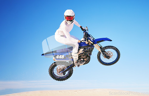 Image of Blue sky, motorbike in air and person with action and extreme sport, speed outdoor and mockup space. Adventure, fitness and training, motorcycle jump stunt and freedom, challenge and performance