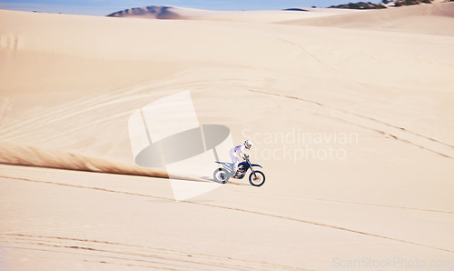 Image of Bike, sports and speed with a man in the desert for a fitness, freedom or an adrenaline hobby. Motorcycle, training and summer with a male athlete riding a vehicle in Dubai for energy on space