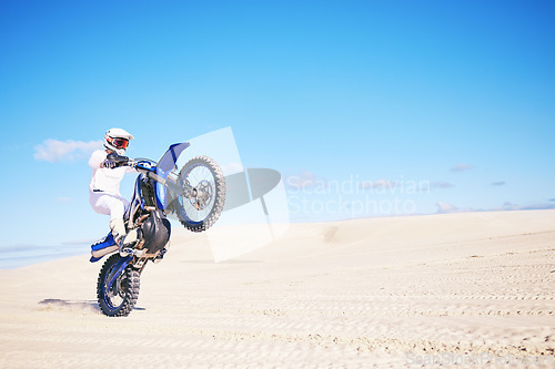 Image of Bike, mockup and balance with a man in a desert for fitness or an adrenaline hobby on space. Motorcycle, skill and summer with a male sports athlete riding a vehicle in Dubai for freedom or energy