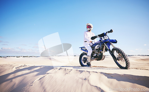 Image of Sand, motor sports and man with motorbike for adrenaline, adventure and freedom in desert. Action, extreme challenge and male person on bike on dunes for training, exercise and race or competition
