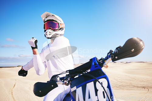 Image of Sports, cycling and man stretching on motorbike on sand for adrenaline, adventure and freedom in desert. Fitness, extreme action and male person on bike on dunes for training, exercise and challenge