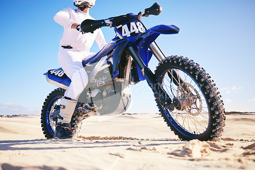 Image of Sand, sports and man with motorbike in desert for adrenaline, adventure and freedom. Competition, extreme action and male person on bike on dunes for training, exercise and race for driving challenge