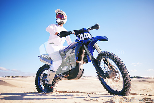 Image of Sand, motor sports and man drive with motorbike for adrenaline, adventure and freedom in desert. Action, extreme sport and male person on bike on dunes for training, exercise and race or challenge