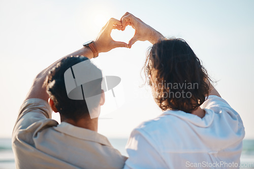 Image of Love, heart hands and gay men on beach, hug from back on summer vacation together in Thailand. Sunshine, ocean and romance emoji, lgbt couple embrace in nature and holiday with pride, sea and fun.