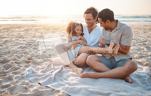 Image of Gay parents, father and girl at beach with love, smile and hug for vacation, laugh or outdoor on sand in sunset. LGBTQ men, young kid and adoption with family, holiday or comic conversation in summer