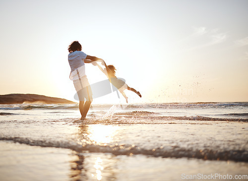 Image of Girl child, swing and father by ocean, sunset and speed for game, holding hands or waves in summer. Young female kid, dad and spin in air, sand or happy for family bonding, love or care in sunshine