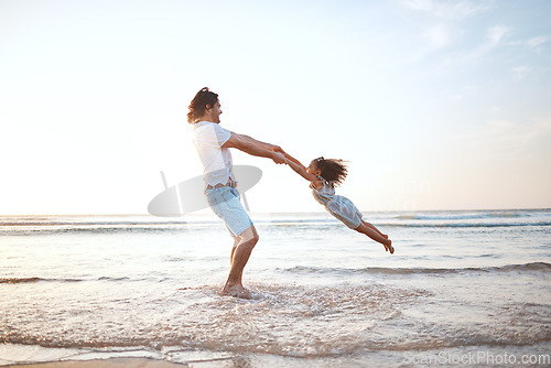 Image of Father, spin girl child and beach with games, holding hands or happy for bonding together by waves. Dad, female kid and swing with love, care and playing by sea, ocean or family on vacation in summer