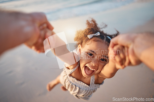 Image of Girl child, spin and pov by ocean, portrait and smile for game, holding hands or speed in summer. Young female kid, parent and swing in air, sand or happy for family bonding, love or care in sunshine