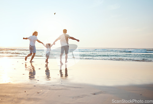 Image of Gay parents holding hands with girl at beach running in water on holiday, vacation and adventure. Lgbtq family, sunset and happy child with fathers by ocean for bonding, relaxing and fun outdoors