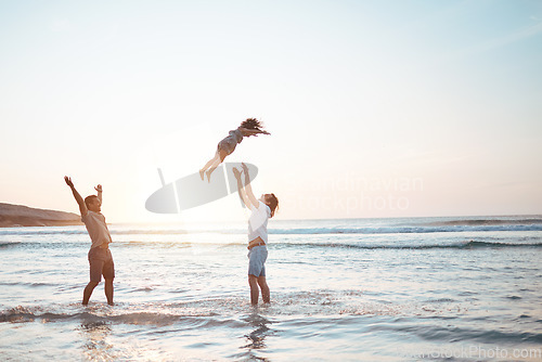 Image of Father, lifting and child in air at beach, sunset and waves in the ocean for happiness, fun and support on adventure. Parents, kid and silhouette of dad in the sea with love to play a game with girl