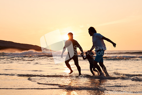 Image of Lgbt family on beach, men and child holding hands at sunset, running in waves and island holiday together. Love, happiness and sun, gay couple on tropical ocean vacation with daughter in silhouette.